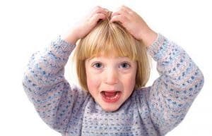 Blond girl with hands on head and surprised face