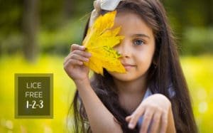 Little girl holding a large yellow leaf, promoting Lice Free 1-2-3 Special