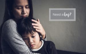 mother comforting sad boy - Give Hugs Not Bugs Campaign