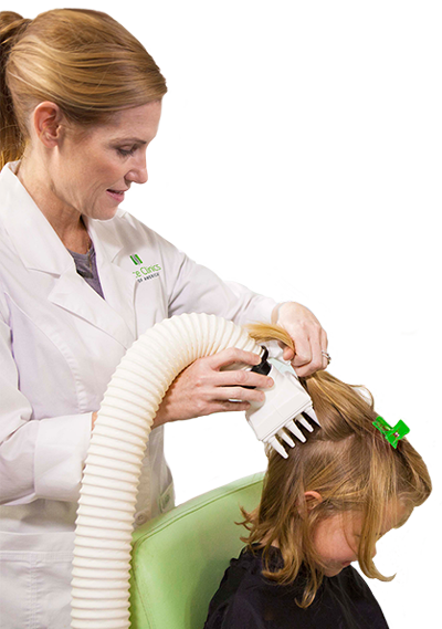 Lice clinics of america clinician combing using heated-air airalle treatment in girls hair to dehydrate head lice
