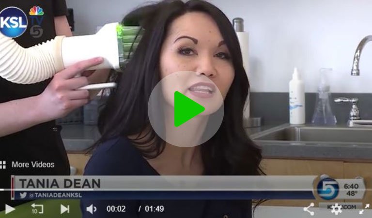 News reporter in a clinic receiving a heated-air lice treatment