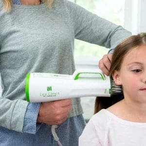 Mom using at-home heated-air device to treat head lice
